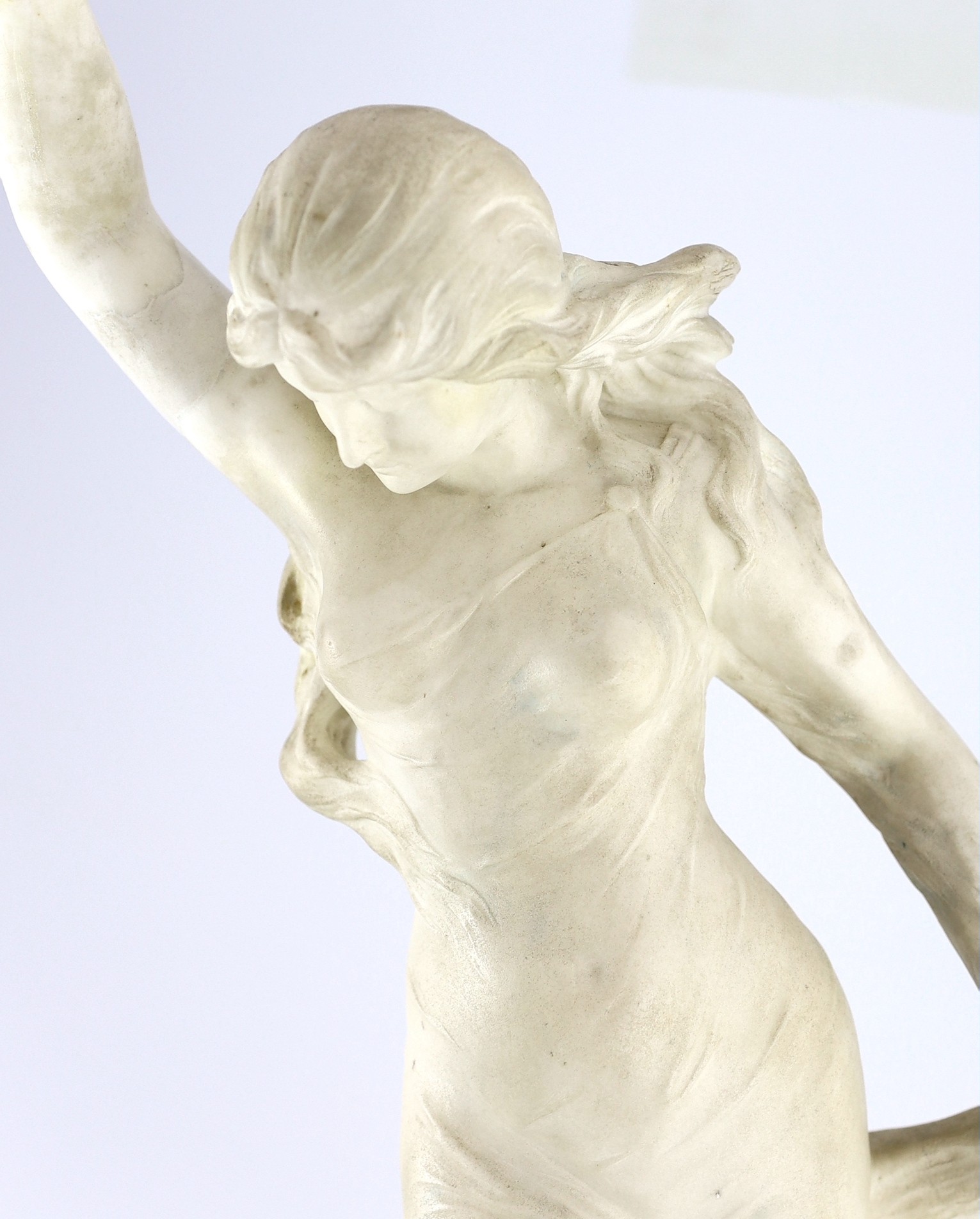 An early 20th century Continental carved white marble figure of a sea nymph riding the waves 79cm high
